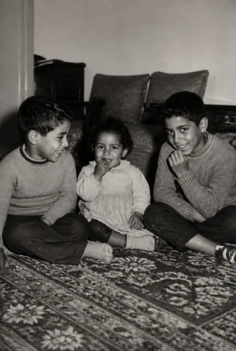 After restoration: Three children behind a repaired fold